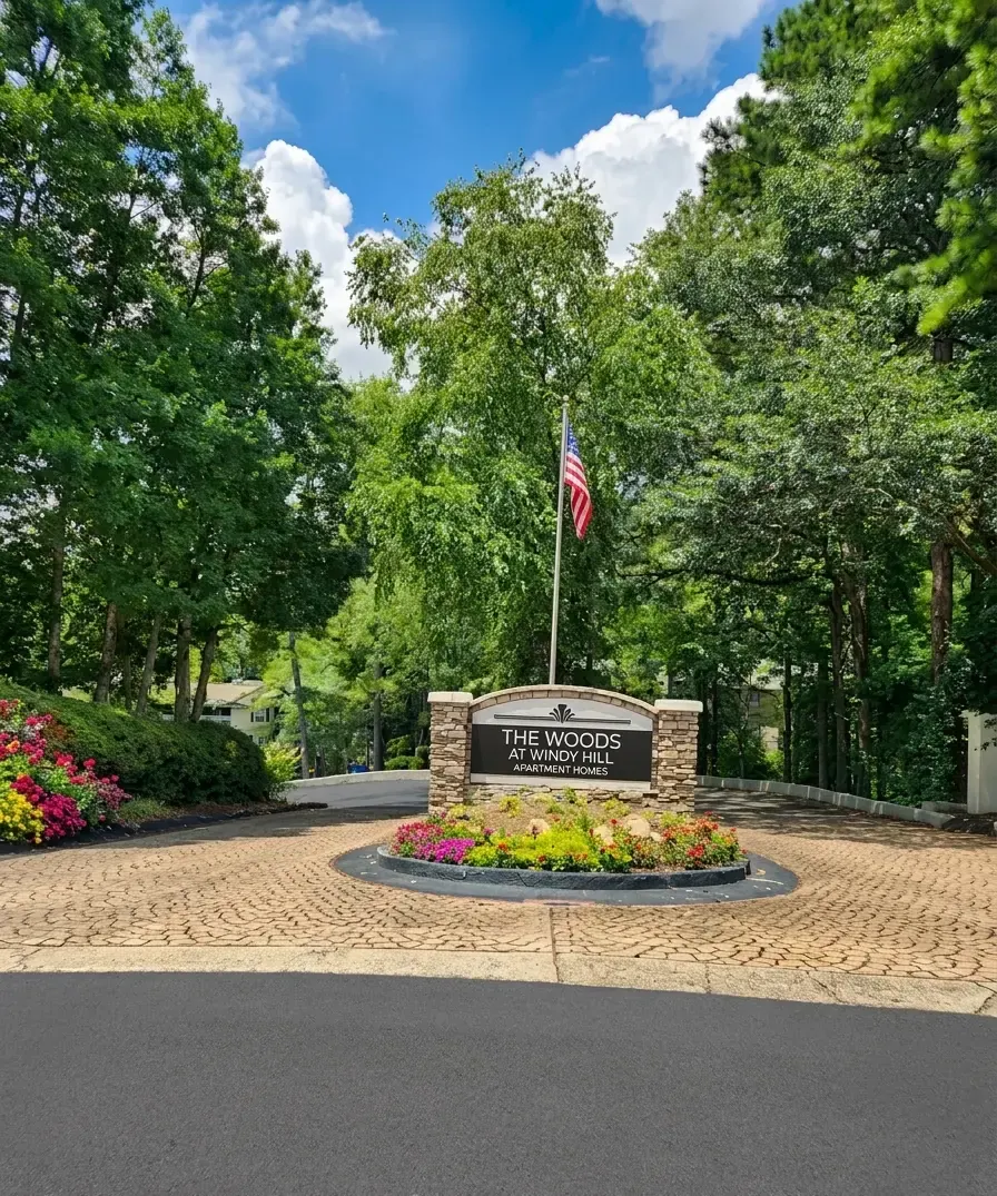 The Woods at Windy Hill entrance sign and flower bed